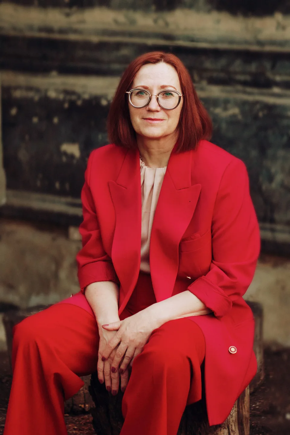 Woman in a red dress sitting outside