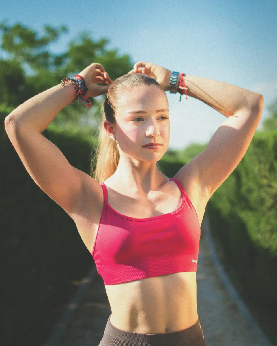 Young woman tying her hair before workout
