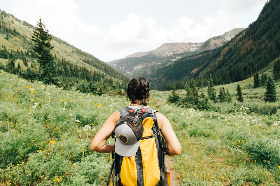 Walk with a backpack on a green trail