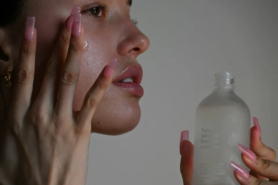 Applying a serum to the cheek